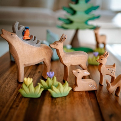 Close-up photo highlighting the smooth, sanded texture of the wooden stag toy.