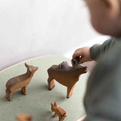 The stag toy featured alongside other Bumbu Toys animal figurines, showcasing a woodland collection.