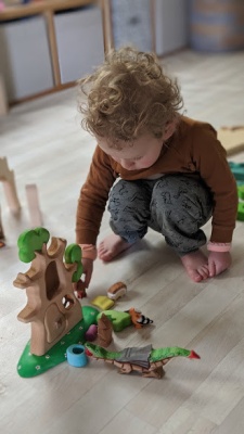 The treehouse displayed on a child's nightstand beside a book about fairytales or treehouses.