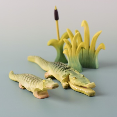 Wooden Baby and adult crocodile surrounded by cattails.