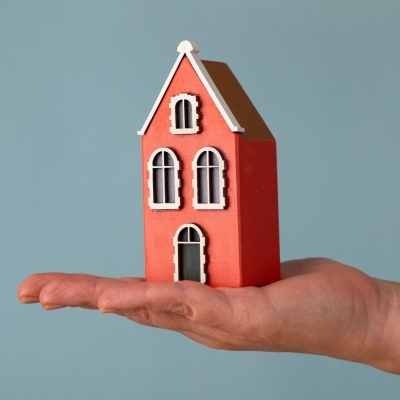 Wooden Gdańsk House displayed in hand for scale.