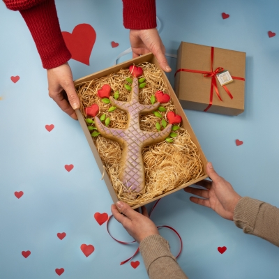 The Heartwood Tree packaged in a gift box with wood wool, being exchanged as a Valentine's gift.