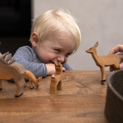 Wooden fawn toy caught in the act of eating, by Bumbu Toys.