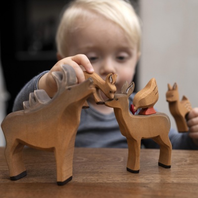 Charming wooden deer toy for storytelling and creative play.
