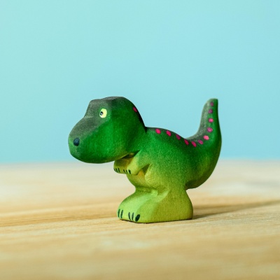 Close-up of the wooden T-Rex Baby toy with non-toxic paint
