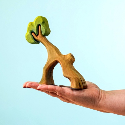Hollow Tree toy held in hand for size comparison