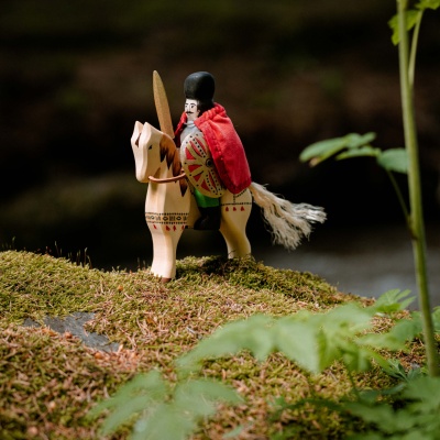 The Michael the Brave and Steed set displayed on a wooden table with other wooden toys, creating a nostalgic and traditional feel.