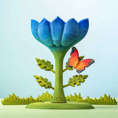 Butterfly figurine on a green and blue nature-themed setup