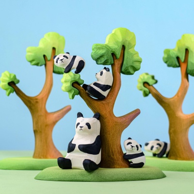 Group of wooden panda bears and trees in a play setting
