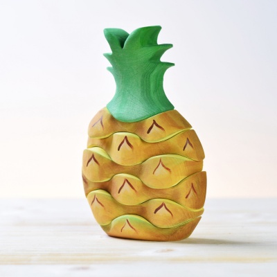 BumbuToys' Pineapple, a hand-painted wooden toy stacker with a striking resemblance to the tropical fruit.