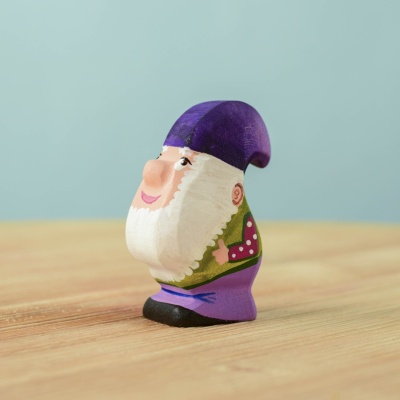 Handcrafted wooden Grumble Dwarf toy with a purple hat and detailed painting.