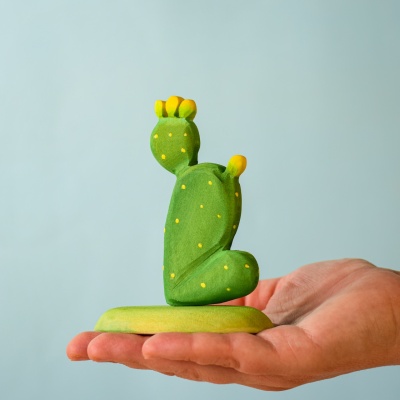 Handcrafted wooden prickly pear cactus held in a hand