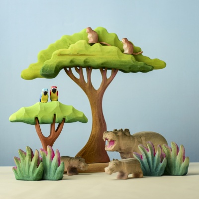 Wooden Hippo Baby toys in a forest scene with other animal toys.