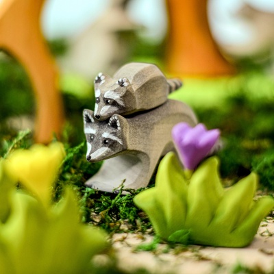 Wooden raccoon by a tree
