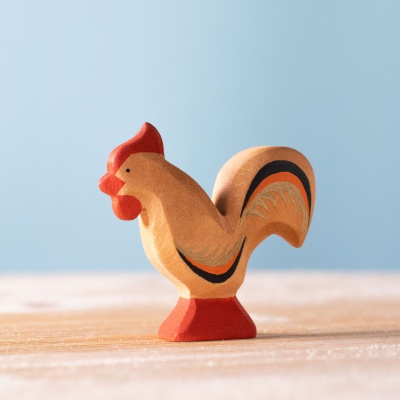 Close-up of the rooster figurine, highlighting its vibrant colors, intricate details, and hand-painted comb.