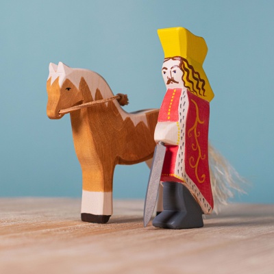 Stephen the Great wooden figure on a bookshelf with history books