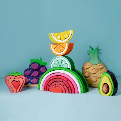 A delectable wooden watermelon by BumbuToys that promotes fine motor skills.