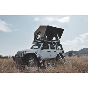 Cortul de acoperiș montat pe un Jeep Wrangler, cu o persoană în natură.
