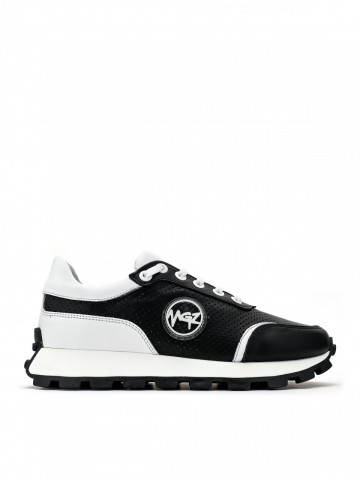 Sports shoes made of natural leather with perforation in black and white color and logo