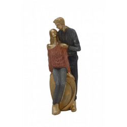 Statueta moderna in haine colorate cu fata stand pe o piatra aurie in forma de inima