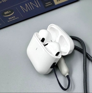 Headset in open charging case showing charging pins