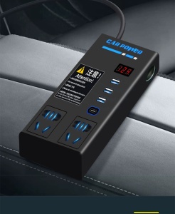 In-car photo of the 200W inverter on a seat, with LED display and illuminated dual AC outlets.