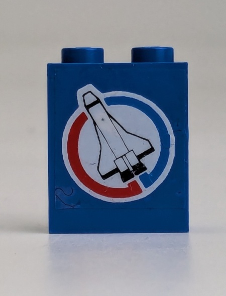 4864apb006L-7G Paneel 1x2x2 met raket in cirkel LINKS (sticker) blauw gebruikt *0D0000