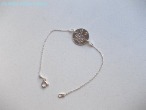 Sterling silver bracelet with flower engraved disk