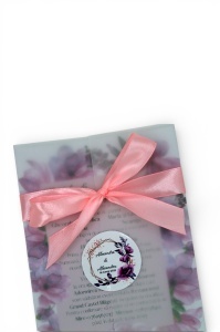 Fundiță roz din satin și sticker personalizat, detalii elegante pentru invitații de nuntă.