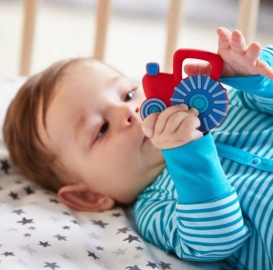 Jucăria HABA Baby Mașină Tractor pentru bebeluși, cu design colorat și material moale, ideală pentru stimularea senzorială, dezvoltarea motricității și calmarea gingiilor în perioada dentiției.