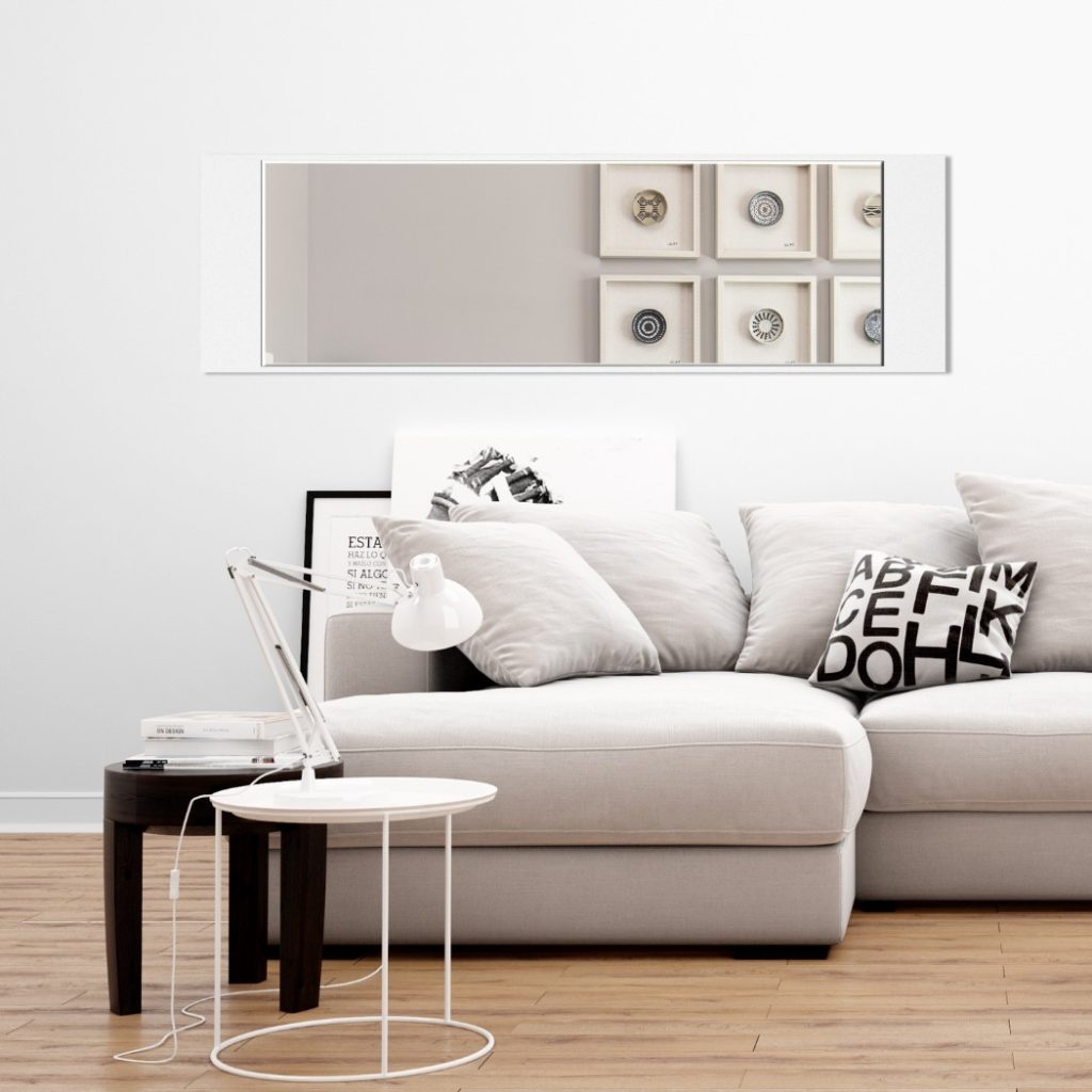 , 2, Oglinda decorativă de perete Pure Style montată deasupra unei canapele într-un living modern.