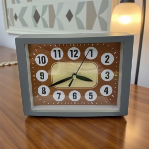 Ceas analogic de noptieră cu design retro, carcasă gri și mecanism quartz, perfect pentru dormitoare