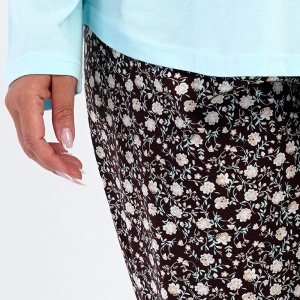 Detaliu de aproape cu textura din tricot de bumbac 100% și imprimeul integral al pantalonilor maro închis.
