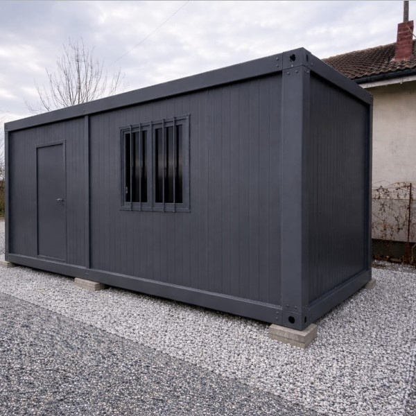 Container metalic compact, ideal pentru depozitare sau spațiu de lucru în curte.