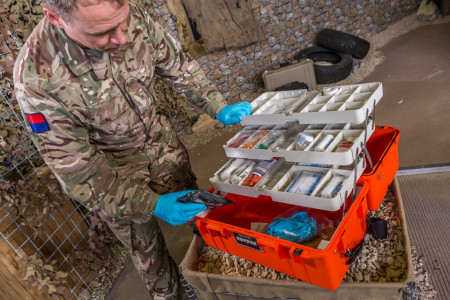 Consumabile și echipamente medicale ținute în siguranță de către un soldat într-o geantă de urgență Peli 1465EMS Air Case