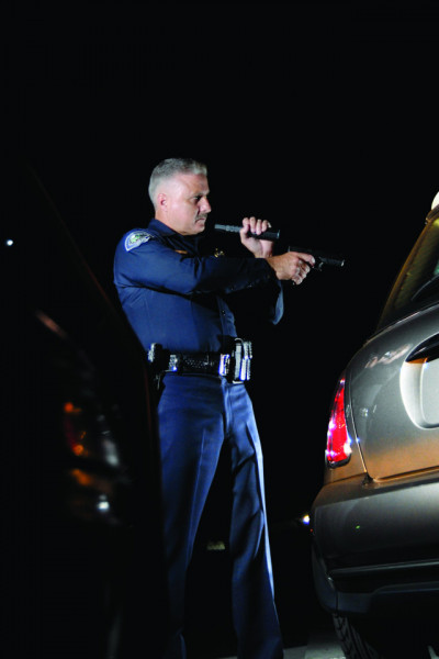 Lanternă de poliție Peli Tactical Flashlight 7060 utilizată de un polițist într-o intervenție