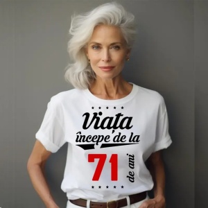 Femeie care poartă un tricou alb personalizat cu mesajul: ''Viața începe de la 71 de ani''