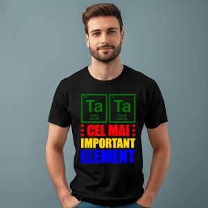 Tânăr zâmbitor purtând un tricou negru cu design inspirat din tabelul periodic al elementelor, prezentând Tantal (Ta) și mesajul colorat 'Cel mai important element' scris în roșu, galben și albastru, pozând pe un fundal simplu verde.