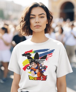 Femeie cu păr scurt și ondulat, purtând un tricou alb cu un design grafic ce prezintă un personaj din Dragon Ball Z pe un fundal colorat, pozând în mijlocul unei mulțimi în aer liber.