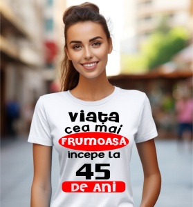 Femeie care poartă un tricou alb personalizat cu mesajul: ''Viata cea mai frumoasa incepe la 45 de ani''.