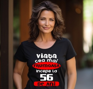 Femeie care poartă un tricou negru personalizat cu mesajul: ''Viata cea mai frumoasa incepe la 56 de ani''.