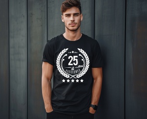Un bărbat zâmbitor purtând un tricou negru cu textul ''25 de ani de excelență'', înconjurat de o coroană de lauri.