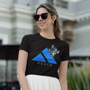 Femeie cu părul prins și purtând ochelari de soare, îmbrăcată într-un tricou negru cu un design ce include un triunghi albastru și un personaj animat albastru(Stitch), ieșind parțial din spatele triunghiului. Sub triunghi se află textul 'PEACE'. Femeia zâ