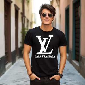 Tânăr modern purtând un tricou negru cu design minimalist, având un logo LV mare și textul 'LASĂ VRĂJEALA'. Poartă ochelari de soare rotunzi și stă într-o alee pietruită, flancată de clădiri colorate cu accente clasice.