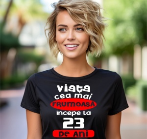 Femeie care poartă un tricou negru personalizat cu mesajul: ''Viata cea mai frumoasa incepe la 23 de ani''.
