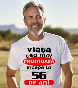 Un bărbat purtând un tricou alb cu textul ''Viața cea mai frumoasă începe la 56 de ani''.