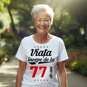 Femeie care poartă un tricou alb personalizat cu mesajul: ''Viața începe de la 77 de ani''