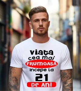 Un bărbat purtând un tricou alb cu textul ''Viața cea mai frumoasă începe la 21 de ani''.