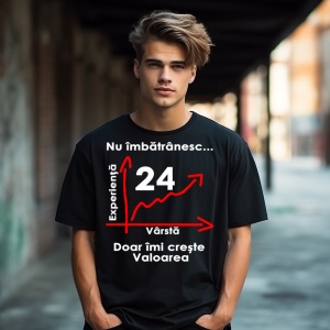 Un tânăr purtând un tricou negru cu mesajul: „Nu îmbătrânesc... Doar îmi crește valoarea” și un grafic care indică vârsta de 24 de ani pe axa vârstei și experienței. Tânărul se află într-un cadru urban, sub o pasarelă, cu clădiri în fundal.