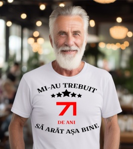 Un bărbat purtând un tricou alb cu mesajul: „Mi-au trebuit 71 de ani să arăt așa bine”